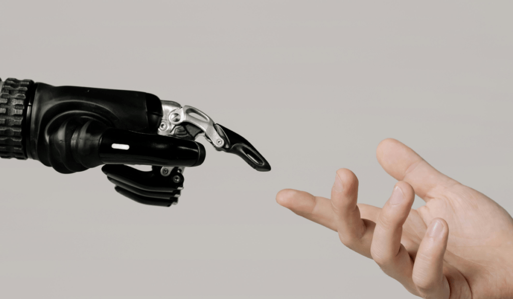 Human hand reaching toward a robotic hand, symbolizing AI vs human connection in court reporting and legal services